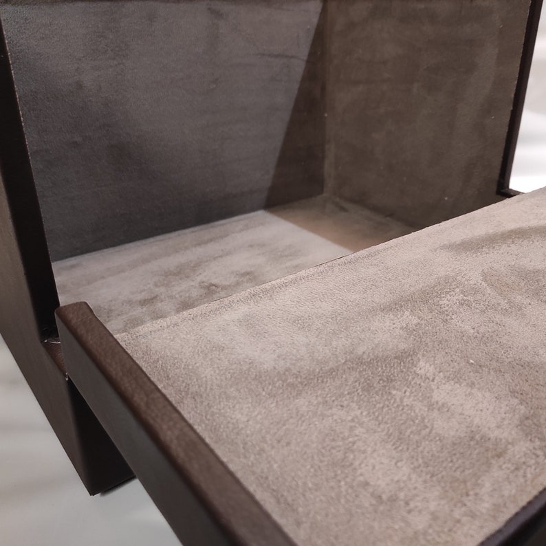 Coffret en cuir marron avec fermoirs dorés, idéal pour homme, conçu pour le rangement de bijoux, documents et accessoires de bureau, combinant élégance et fonctionnalité.