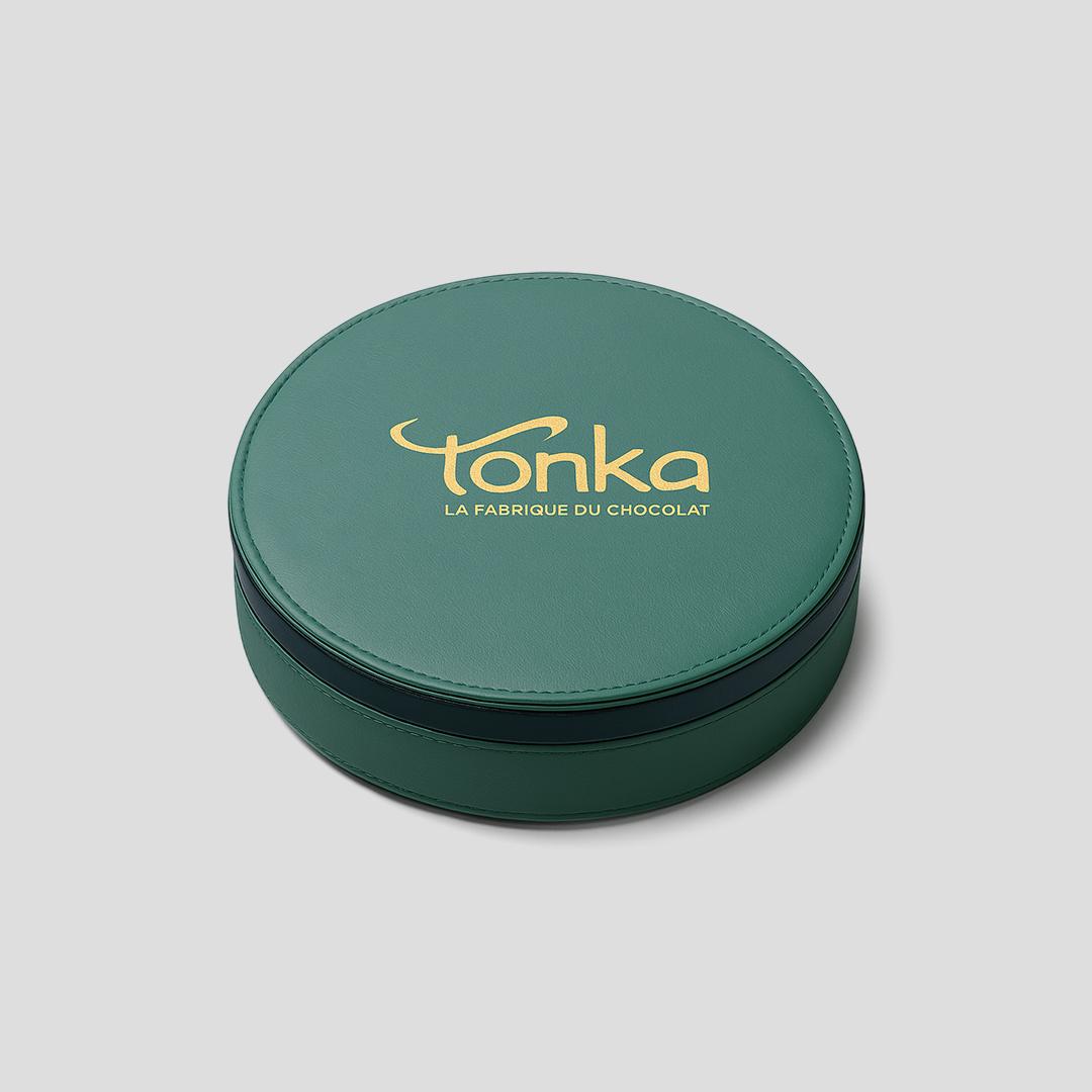 Emballage de luxe : coffret de forme ronde et de couleur verte.