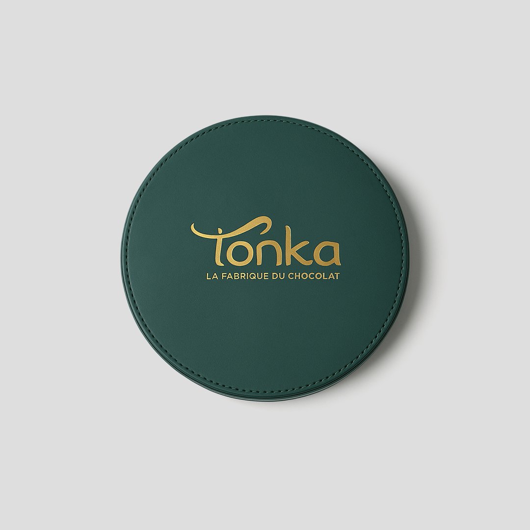 Emballage de luxe sur mesure: coffret de forme ronde et de couleur verte.